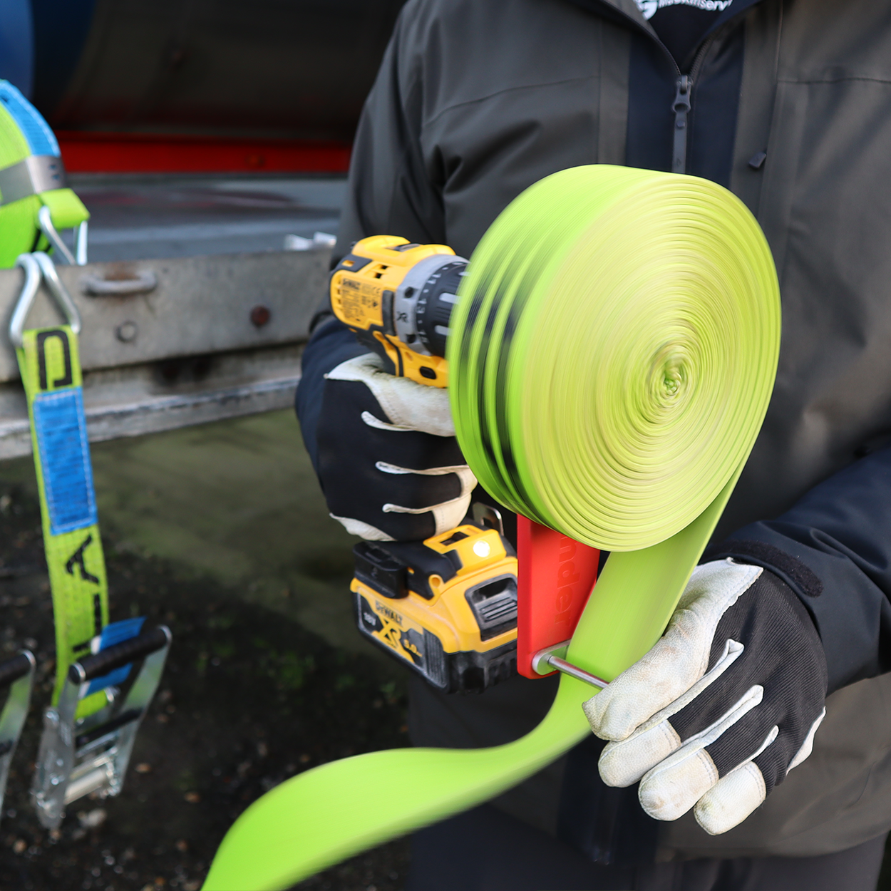 Cordless Drill Attachment Fast Strap Winder held by a person, highlighting its robust bearing handle designed for efficient strap winding.